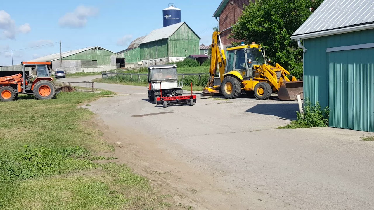 Demo of Yacare magnetic sweeper picking up metal debris at a farm