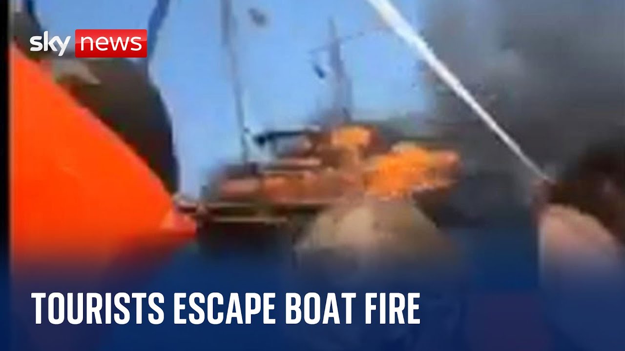 Greece Tourists evacuated after wooden boat catches fire off coast YouTube