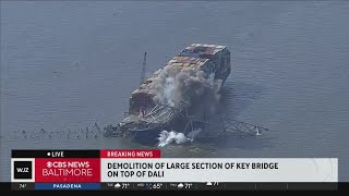 Explosions demolish large piece of Key Bridge from top of container ship