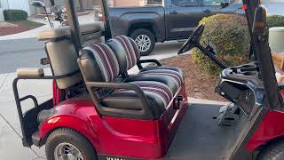 Celebrity Putting gas in golf cart. Wealth