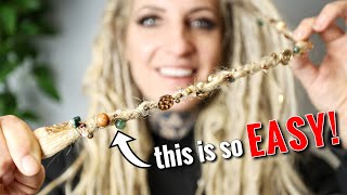 sewing beads onto my dreadlocks