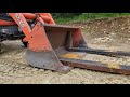 Kubota BX,  backhoe working and homemade FEL bucket Pallet Forks.