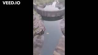 Throwing Large Rock Off Dam