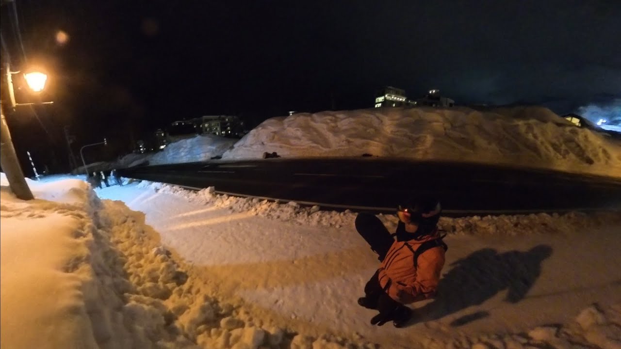After a night of snowboarding, walking to the car through snowy streets. Niseko 2026-02-17.