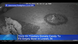 Trick-or-treaters fill empty bowl with own candy in Lowell, Indiana