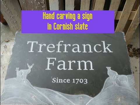 Stone carver Carving a sign in Cornish slate