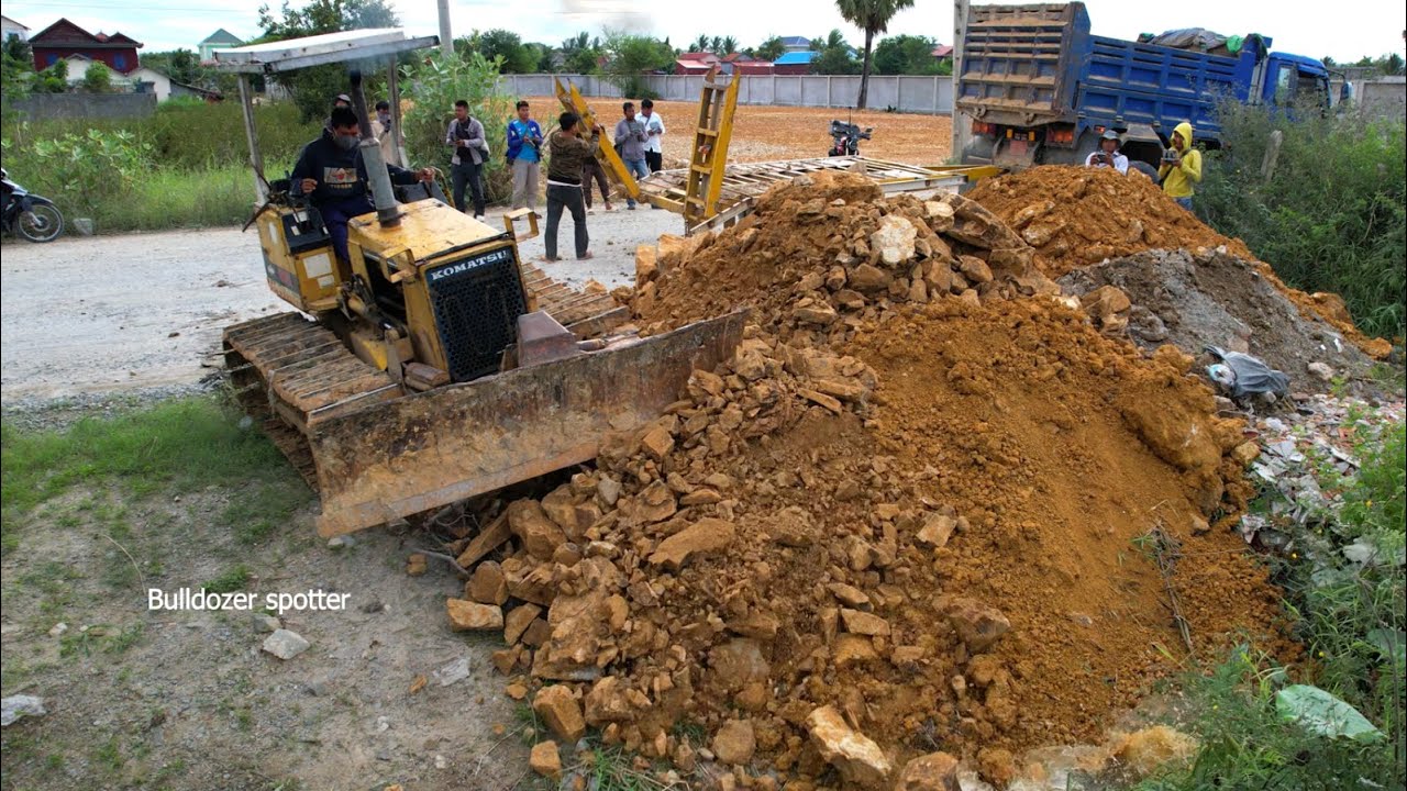 Incredible !! Dump truck unloading soil into the water building new road and bulldozer pushing fill