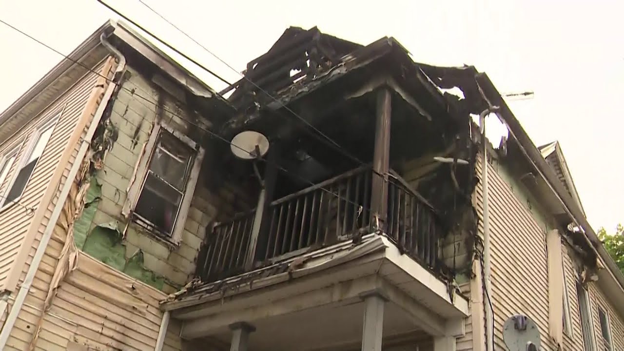 Neighbor spots woman jump from burning building - YouTube