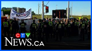 A dozen protesters arrested at military trade show