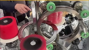 Machine for winding wire and tape wrapping on cores of current transformers; winding+taping