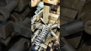 Manufacturing metal compression spring automatically using an industrial CNC spring coiling machine