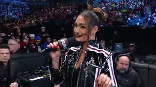 Nikki Bella in leather pants & boots and latex jacket.