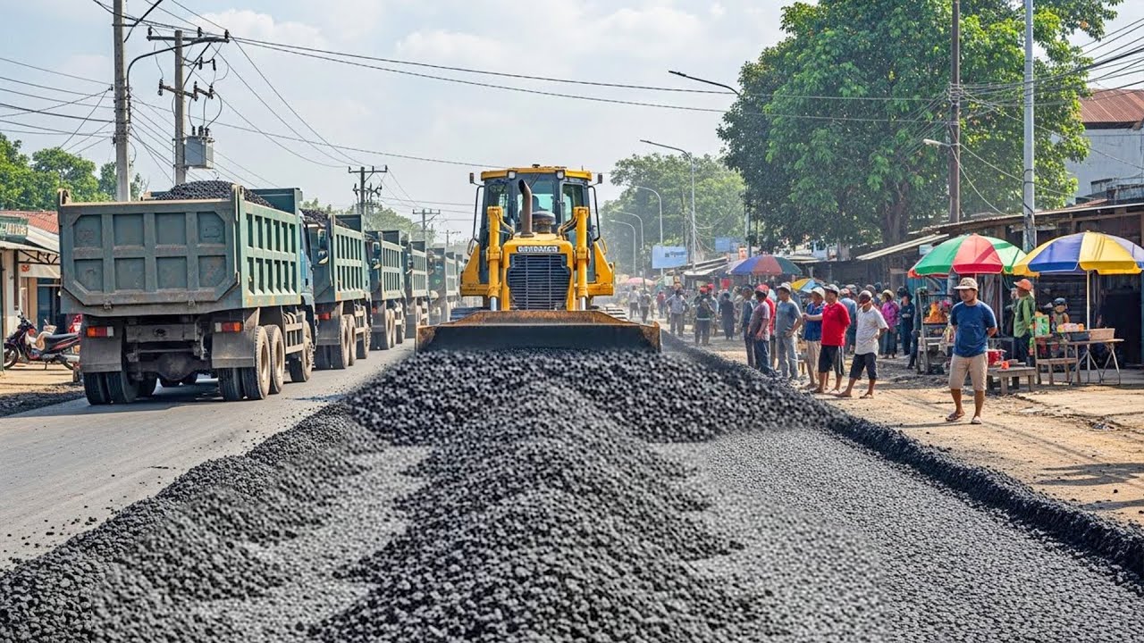Bulldozer Spreading Gravel for Road Construction in Village Area