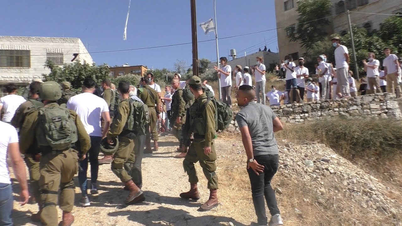 Israeli settlers surround the Abu Shamsiyeh home in Hebron, after attacking family members.