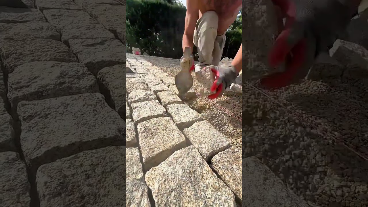 Man shaping granite stones for precise outdoor pavement installation