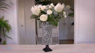 White king proteas with roses and French eucalyptus foliage into a decoupage vase
