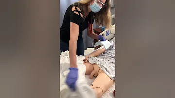 Catheter care on nursing school male mannequin.