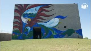 Local artist Wesley May paints mural in BSU's American Indian Resource Center