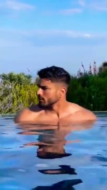 Hot man bathing in pool
