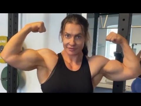 Beautiful muscular woman flexing big biceps 
