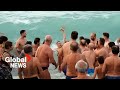 Orthodox Christians across the globe take icy plunges to celebrate Epiphany
