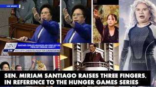 Miriam Santiago raises three fingers in reference to The Hunger Games series