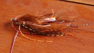 I created this fly to mimic a skirted jig. when conventional fish for
bass, one of my favorite and most productive techniques is flipping
heavy cover with ...