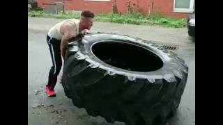 Man Demonstrates Intense Tire Flipping Workout Routine