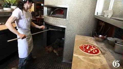 Chef at Rosalie whipping up pizzas at a dizzying p...