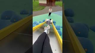Little boy goes down yellow metal slide then falls forward and makes thump noise