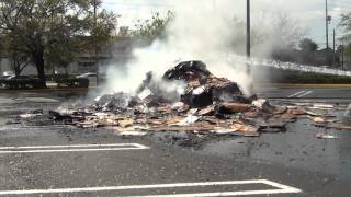 TRASH CAUGHT FIRE IN BACK OF GARBAGE TRUCK HE DUMPED IT IN SHOPPING CENTER PARKING LOT :}:}:}