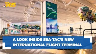 A look inside as the first flight lands at Sea-Tac's brand new international terminal