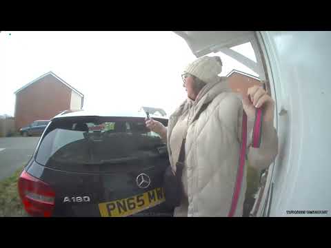 Footage shows woman end up wedged between house and car after forgetting to put handbrake on