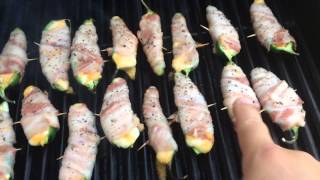 Bacon wrapped cheese stuffed jalapeños on the grill
