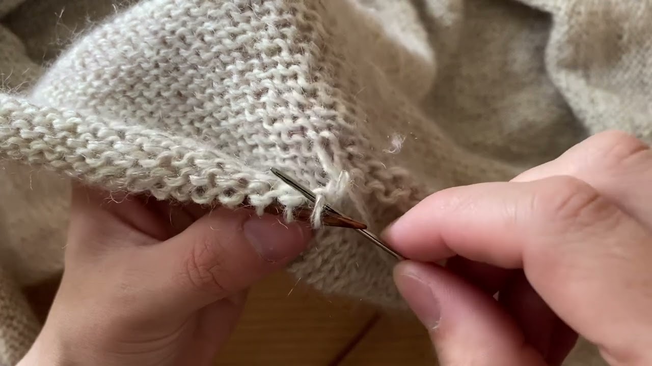 Folding the edge with purl stitches inside and sewing