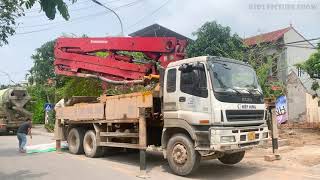Concrete pump truck and concrete mixer truck preparing to construct the house foundation