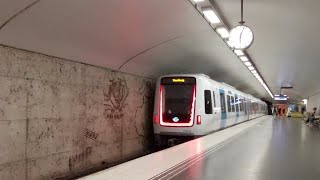 Stockholm metro, Östermalmstorg station, red line. Metro train class C30. Text, subtitles.