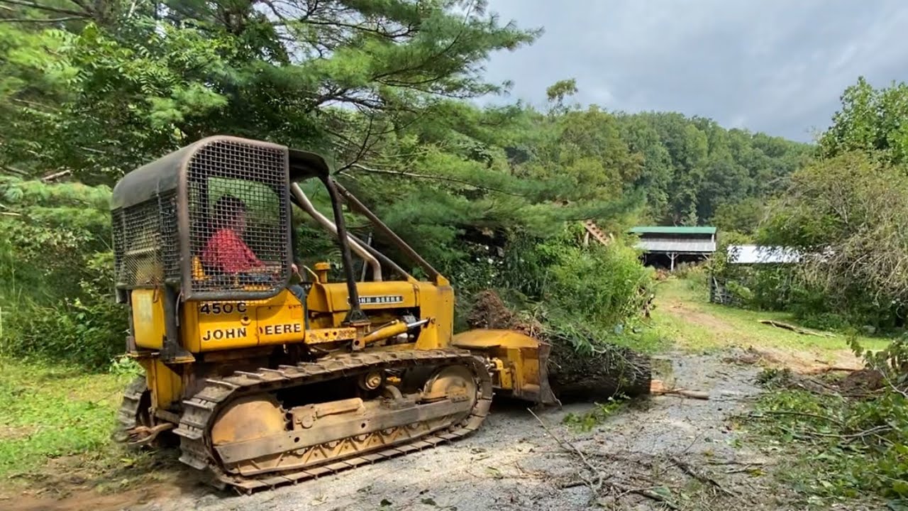 Groundhog cleans up mess from the 450c pushing trees over - YouTube