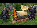  traditional lavash bread baking bread on a barrel over wood fire