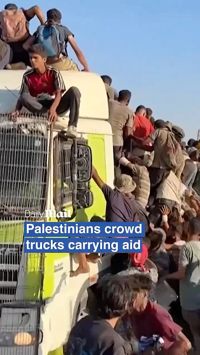 Desperate Palestinians climb moving aid trucks in chaotic scramble for food and supplies