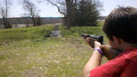 Drew shooting cinder blocks with sks