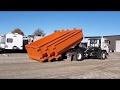How to Unload a Load of Dumpsters From an 18-Wheeler Flatbed with an Isuzu FTR Hook Lift Truck.
