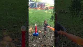 Boy attempts to hit baseball from tee and accidentally hits little brother with plastic bat twice
