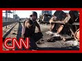 CNN reporter discovers he is crouching by grenade while on air