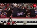 Bloodied Trump fist pumps after shots fired at rally