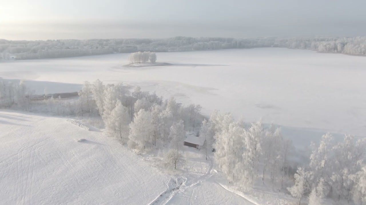 Aerial Serenity in 4K: Snow-Covered Land and Frozen Lake ❄️🏞️