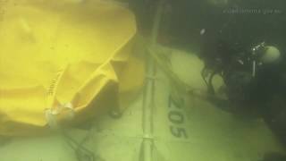 Navy Clearance Dive Team assist in the recovery of a water bombing helicopter.