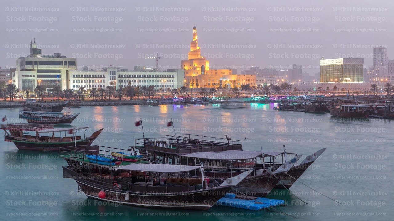 Evening at Doha Bay day to night timelapse with Traditional Wooden Dhow Fishing Boats.