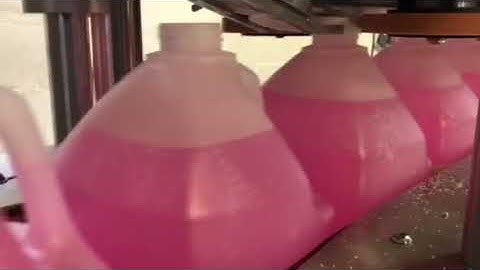 HyTek Automation Solutions - Capper, retorquer, and conveyor - 38mm cap on gallon container