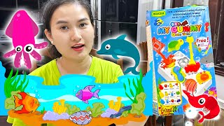 Cam Cam đi siêu thị mua kẹo dẻo tự làm hình các con cá: cá mập, con mực, cá voi, sư tử biển.
